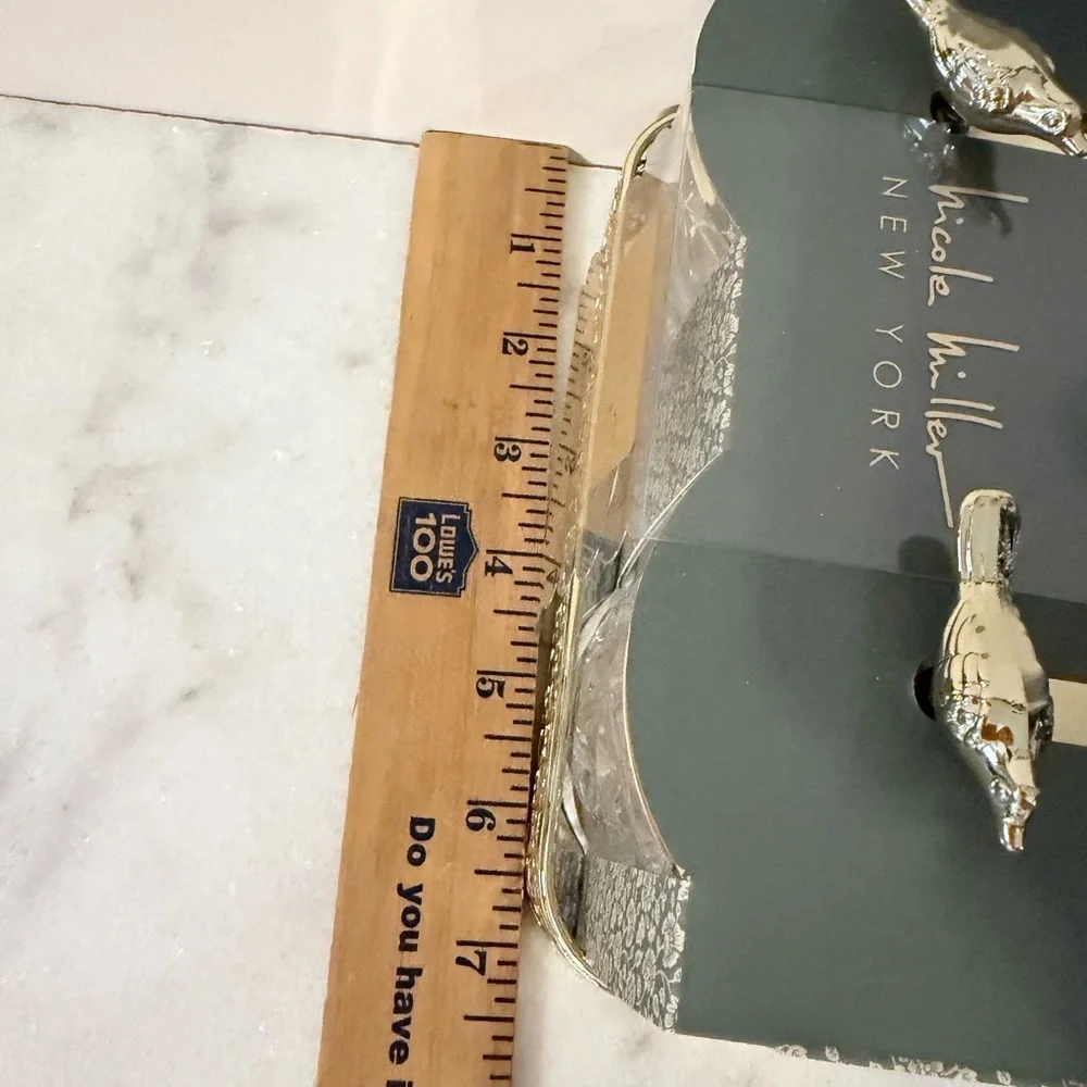 two-piece glass storage jar set with a gold bird lid and decorative tray.